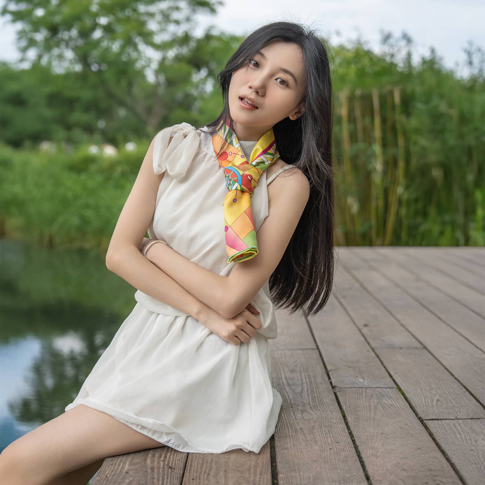 Elegant woman wearing printed silk scarf