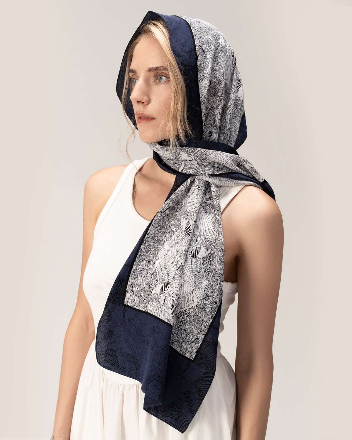 Model in blue and white silk headscarf