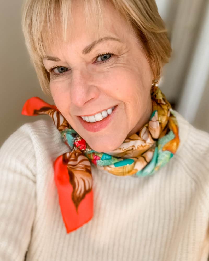 Silk scarf paired with knit sweater